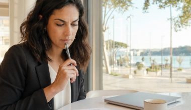 Femme réfléchissant sur des documents à une table